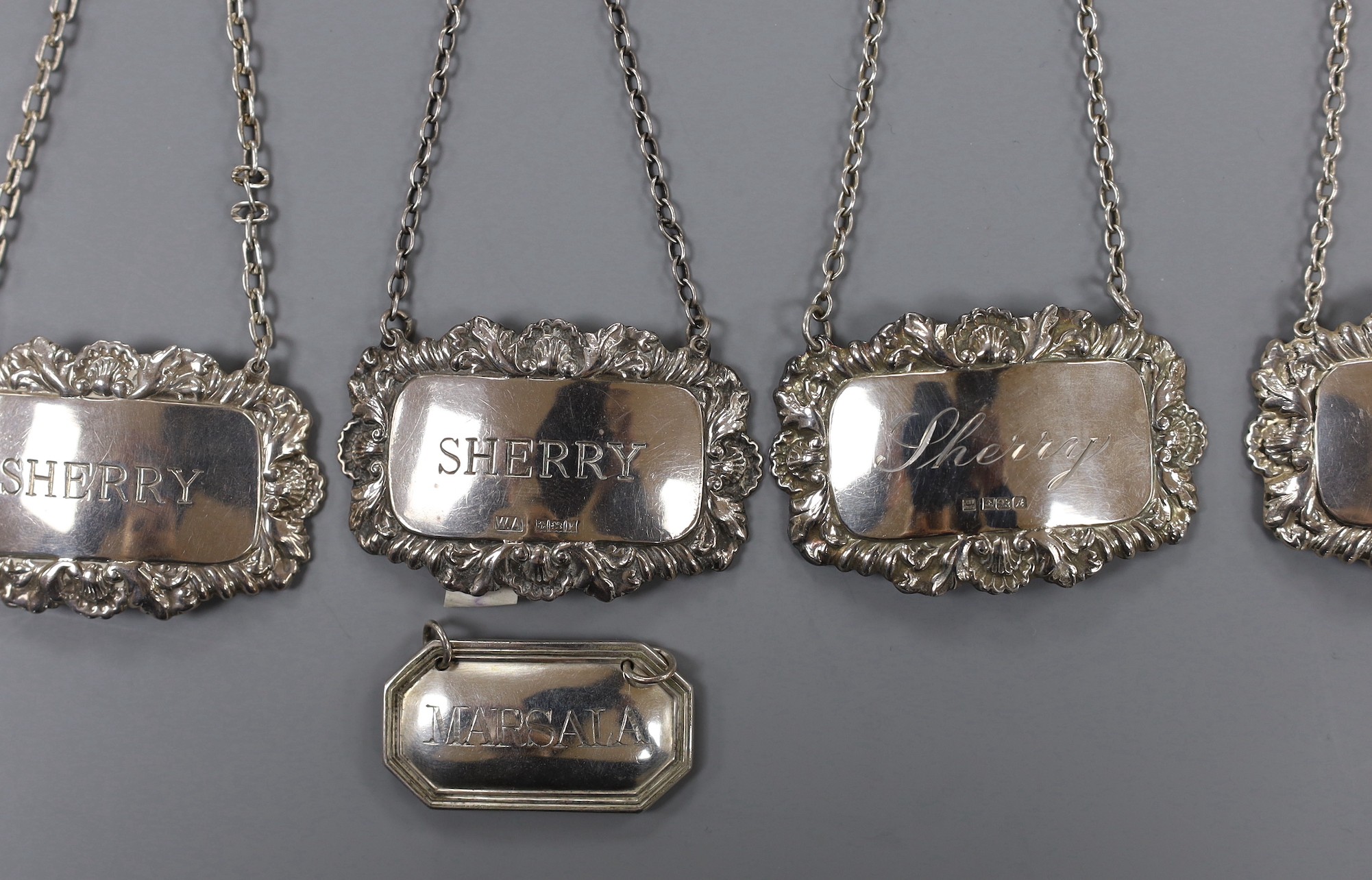 A modern pair of silver 'Sherry' & 'Madeira' wine labels, three other silver 'Sherry' wine labels and a plated wine label.